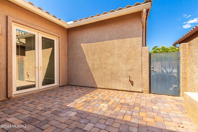 view of patio / terrace with french doors and a gate