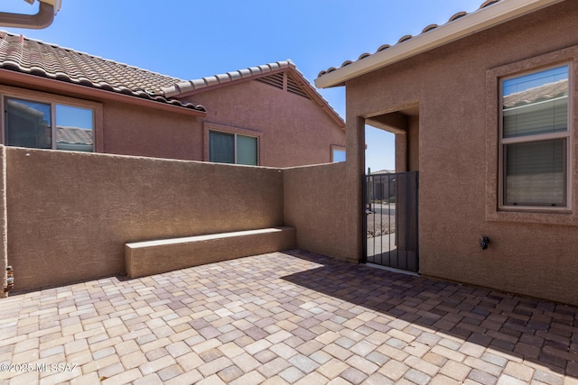 view of patio featuring a gate and fence