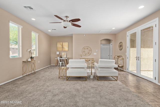 living room featuring french doors, arched walkways, a ceiling fan, and recessed lighting