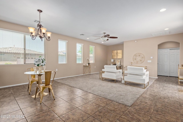 tiled living area with arched walkways, baseboards, recessed lighting, and visible vents