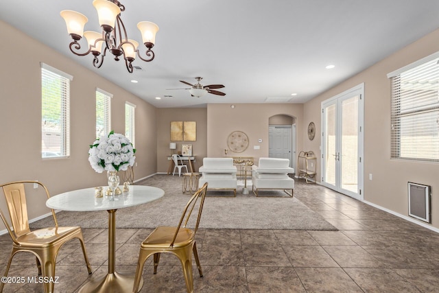 dining room with arched walkways, baseboards, recessed lighting, and ceiling fan with notable chandelier