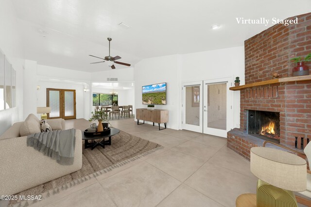 12471 E Speedway Blvd, Tucson, AZ 85748 - tiled living room featuring french doors, ceiling fan, a brick fireplace, and high vaulted ceiling