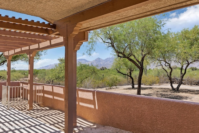 balcony with a pergola and a mountain view