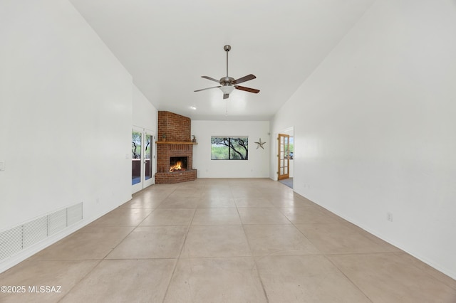 12471 E Speedway Blvd, Tucson, AZ 85748 - unfurnished living room featuring healthy amount of natural light, ceiling fan, a brick fireplace, and lofted ceiling