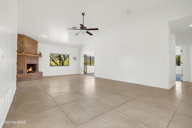 12471 E Speedway Blvd, Tucson, AZ 85748 - unfurnished living room featuring a ceiling fan, a brick fireplace, concrete flooring, and high vaulted ceiling