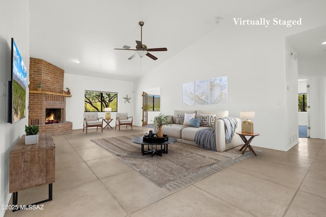 12471 E Speedway Blvd, Tucson, AZ 85748 - living area featuring ceiling fan, a brick fireplace, concrete floors, and high vaulted ceiling