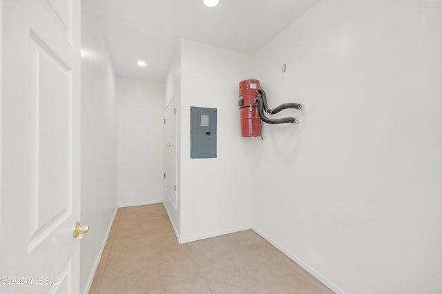 corridor with electric panel, baseboards, and recessed lighting