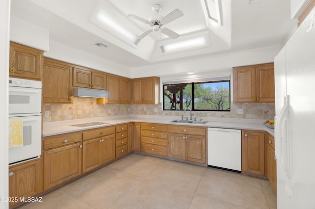 12471 E Speedway Blvd, Tucson, AZ 85748 - kitchen with white appliances, a tray ceiling, tasteful backsplash, light countertops, and ceiling fan