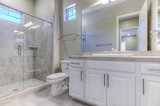 full bathroom featuring vanity, toilet, a shower stall, and tile patterned floors