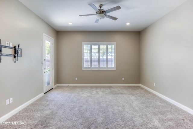 empty room featuring carpet, baseboards, and a ceiling fan
