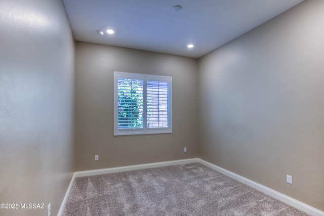 empty room with carpet flooring, baseboards, and recessed lighting