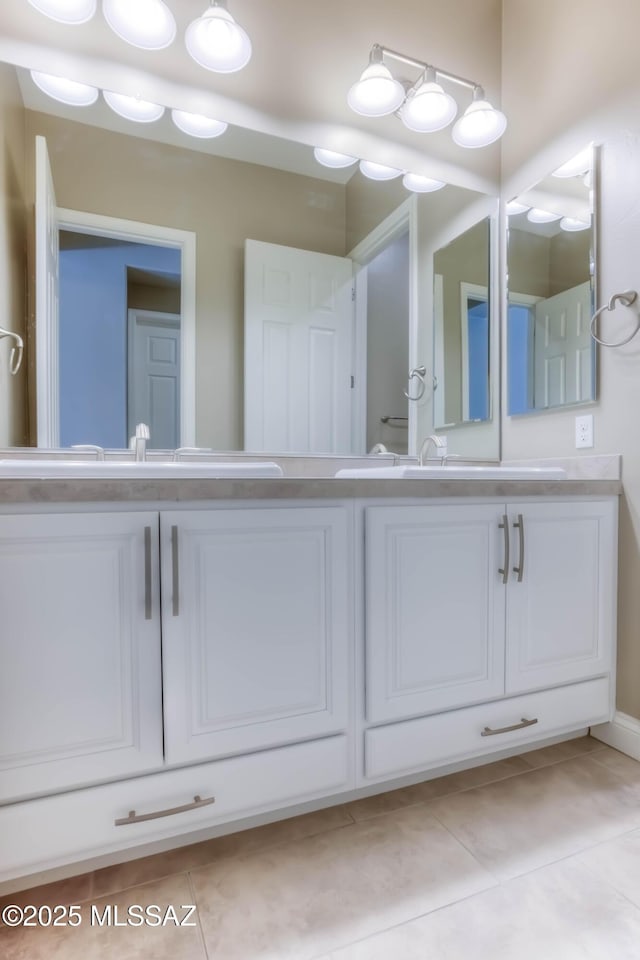 full bathroom with a sink, tile patterned flooring, and double vanity