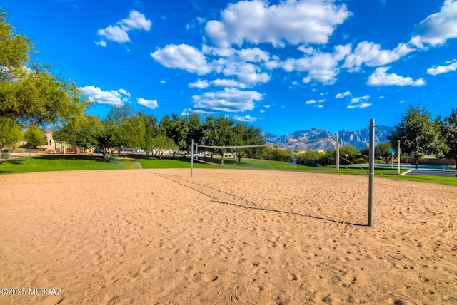 surrounding community with a mountain view and volleyball court