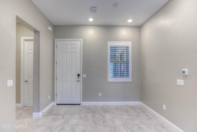 entrance foyer with baseboards and recessed lighting