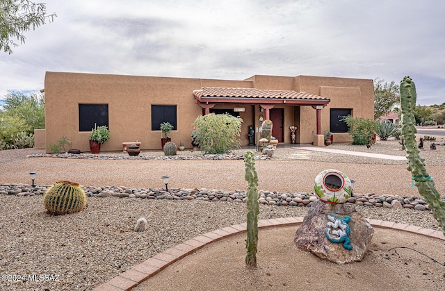 pueblo-style house with stucco siding