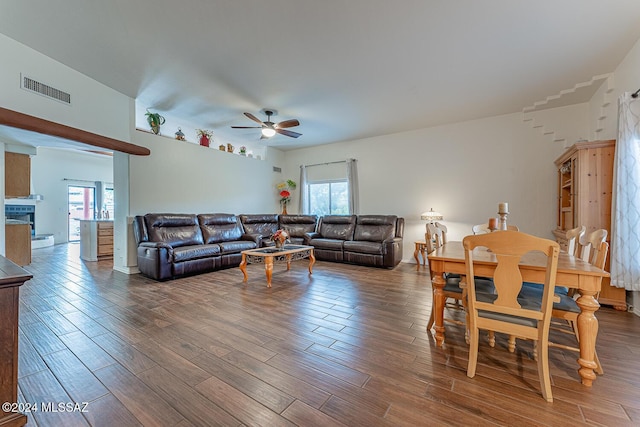 living area featuring a healthy amount of sunlight, ceiling fan, wood finished floors, and visible vents