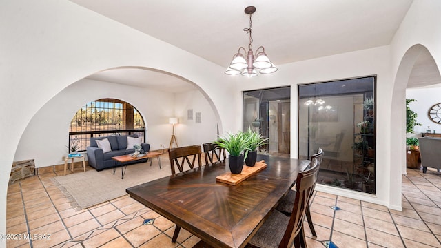 900 N Camino Del Codorniz, Tucson, AZ 85749 - dining space featuring light tile patterned floors and a chandelier