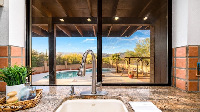 900 N Camino Del Codorniz, Tucson, AZ 85749 - kitchen view of a sink and stone counters