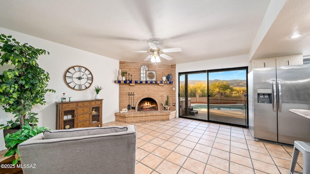 900 N Camino Del Codorniz, Tucson, AZ 85749 - living room with ceiling fan, light tile patterned flooring, and a fireplace