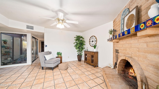 900 N Camino Del Codorniz, Tucson, AZ 85749 - sitting room with a fireplace, a ceiling fan, and light tile patterned floors