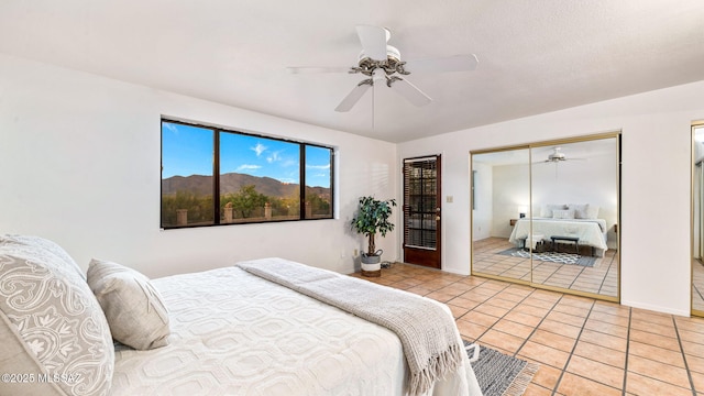 900 N Camino Del Codorniz, Tucson, AZ 85749 - bedroom featuring light tile patterned flooring and a ceiling fan