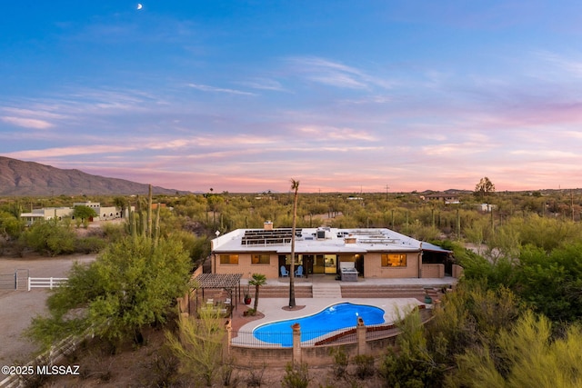 900 N Camino Del Codorniz, Tucson, AZ 85749 - back of house with a mountain view, an outdoor pool, a patio area, a chimney, and brick siding