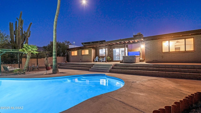 900 N Camino Del Codorniz, Tucson, AZ 85749 - pool at twilight featuring a patio area and a pergola