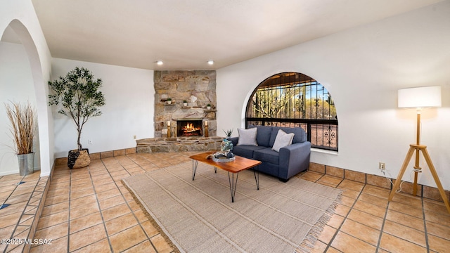 900 N Camino Del Codorniz, Tucson, AZ 85749 - tiled living area with a fireplace, arched walkways, and recessed lighting