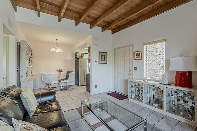 living area featuring beamed ceiling, an inviting chandelier, wood ceiling, and tile patterned flooring