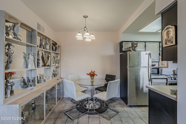 dining room with a notable chandelier, visible vents, and light tile patterned floors