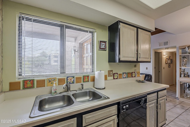 kitchen featuring visible vents, dishwasher, a sink, light countertops, and light tile patterned flooring