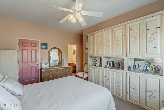 carpeted bedroom with ceiling fan and connected bathroom