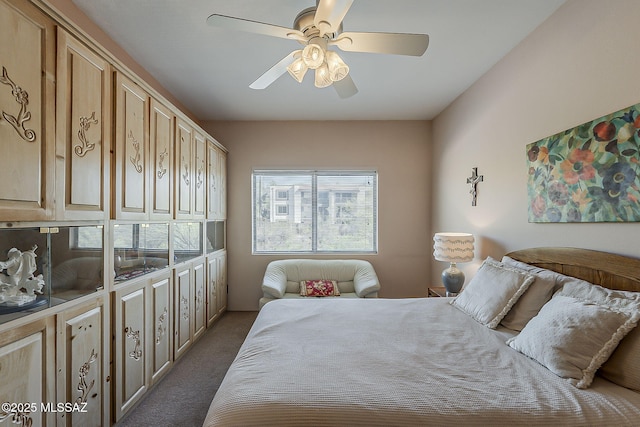 bedroom with dark colored carpet and a ceiling fan