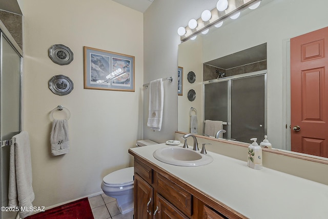 bathroom with vanity, a stall shower, tile patterned floors, and toilet