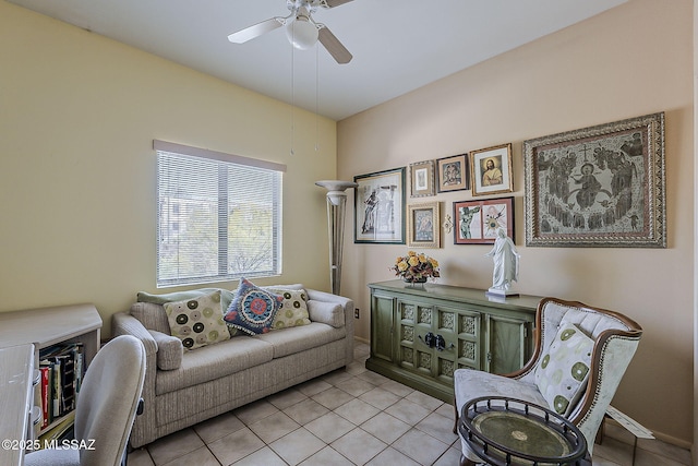 living area with ceiling fan and light tile patterned floors