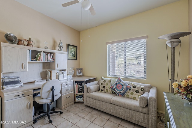 office space with a ceiling fan and light tile patterned floors
