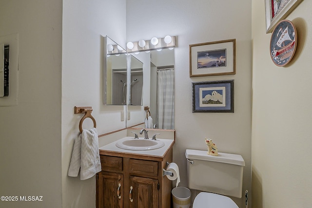 full bath featuring vanity and toilet
