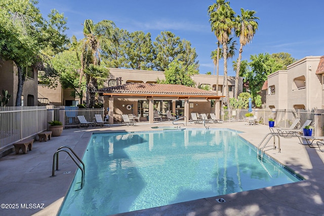 pool with fence, a residential view, and a patio area