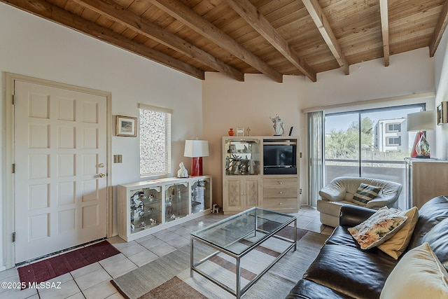 living room featuring wood ceiling, light tile patterned floors, and beamed ceiling