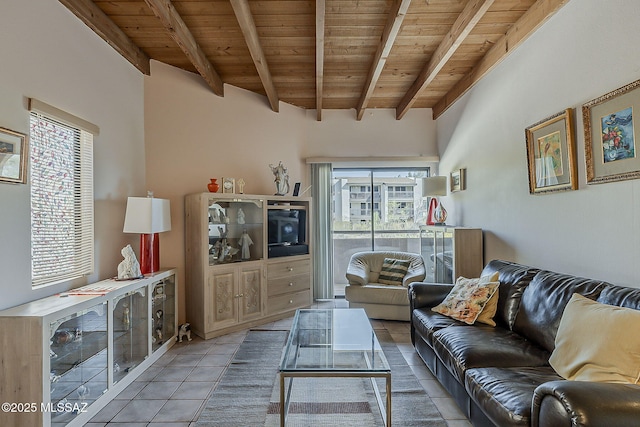 living area with beam ceiling, wood ceiling, and tile patterned flooring