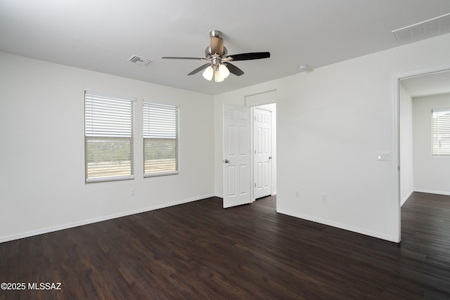 empty room featuring visible vents, a ceiling fan, and plenty of natural light