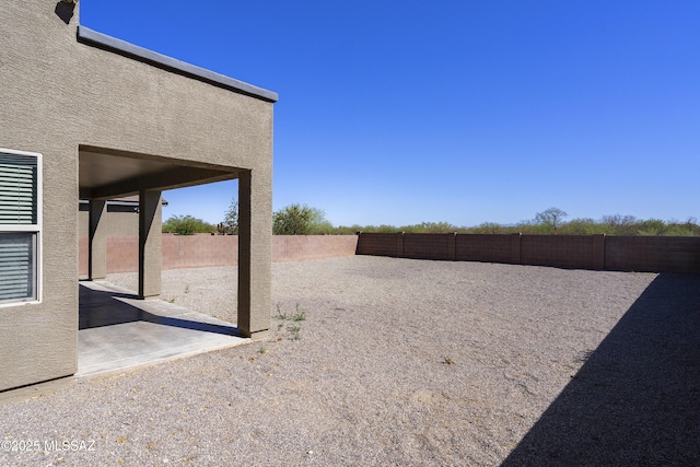 view of yard with a fenced backyard and a patio area