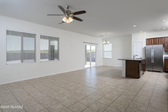 interior space with recessed lighting, a sink, light tile patterned floors, and ceiling fan with notable chandelier