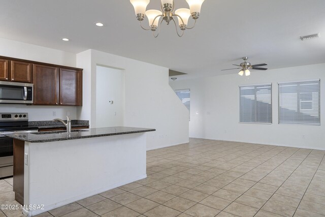 1139 E Madera Grove Ln, Sahuarita, AZ 85629 - kitchen featuring dark brown cabinetry, visible vents, appliances with stainless steel finishes, a sink, and dark stone counters