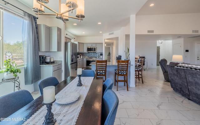 dining area featuring visible vents, recessed lighting, a chandelier, and marble finish floor