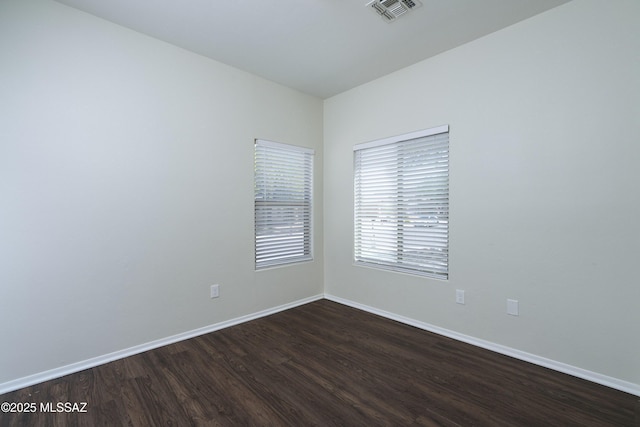 493 E Placita Nodo, Sahuarita, AZ 85629 - empty room with visible vents, dark wood finished floors, and baseboards