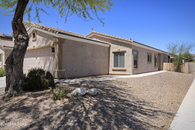 493 E Placita Nodo, Sahuarita, AZ 85629 - back of house featuring an attached garage, fence, a tile roof, and stucco siding