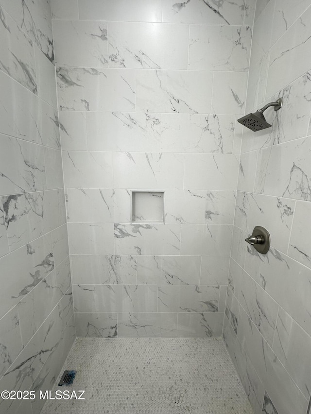 full bath with a tile shower