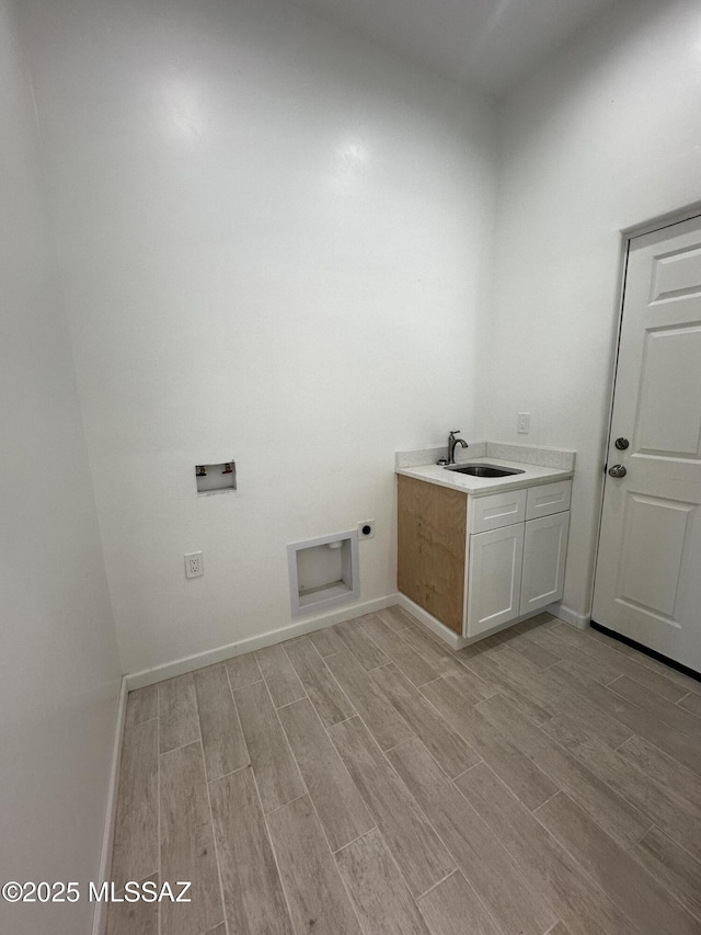 laundry area featuring hookup for a washing machine, light wood-style flooring, cabinet space, and hookup for an electric dryer
