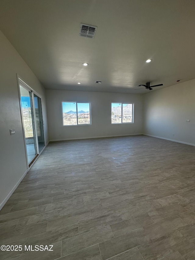 unfurnished room with baseboards, plenty of natural light, and visible vents